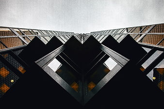 Symmetrical low-angle view of modern glass skyscraper architecture