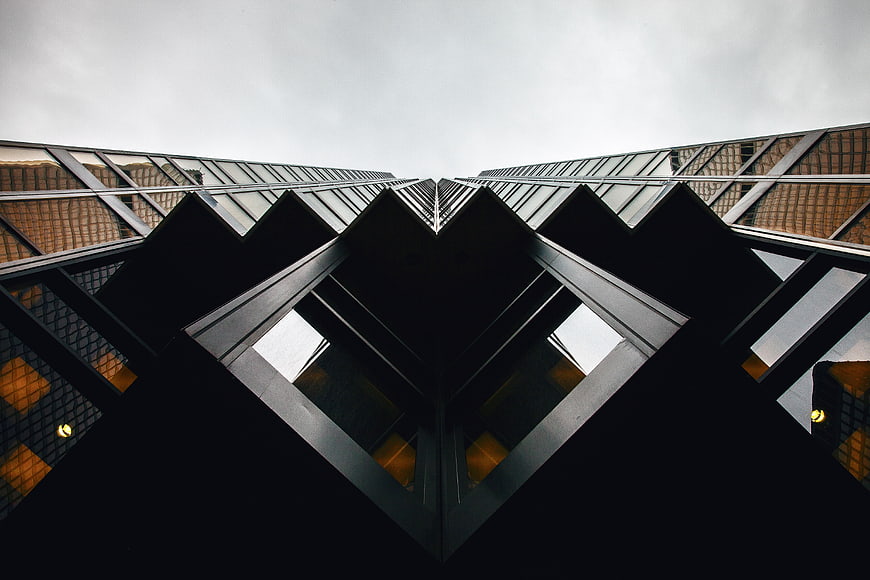 Symmetrical low-angle view of modern glass skyscraper architecture
