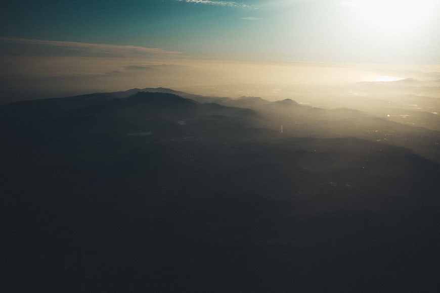 Aerial View of Misty Mountains at Sunset