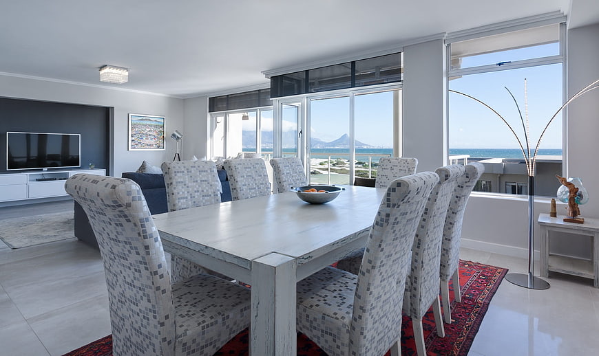 Bright Modern Dining Room With Ocean View And White Furniture