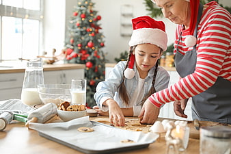 Grandmother and granddaughter baking Christmas cookies together