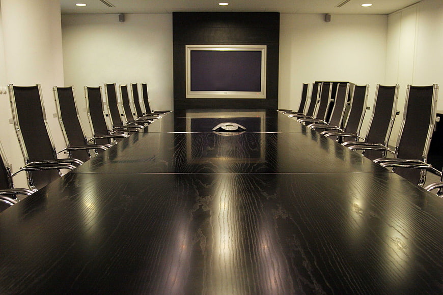 Empty modern conference room with long dark table