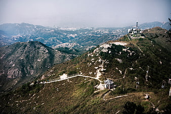 Panoramic mountain landscape with hiking trail and communication tower