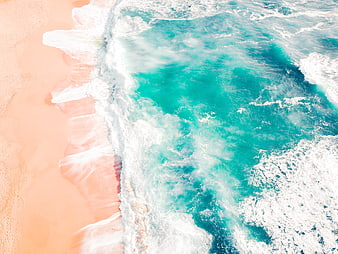 Aerial View of Turquoise Waves Crashing on Sandy Beach