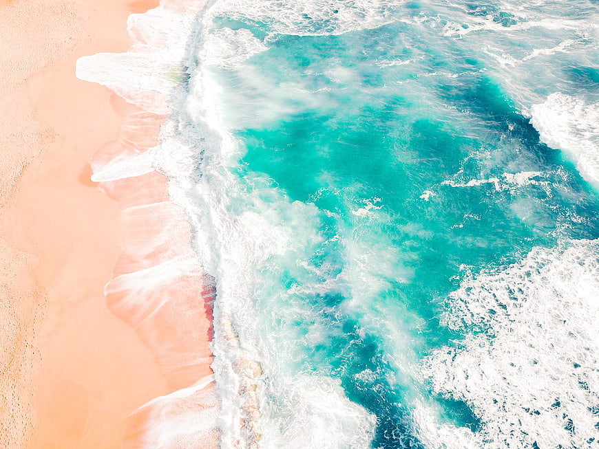 Aerial View of Turquoise Waves Crashing on Sandy Beach