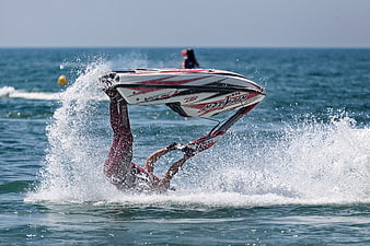 Jet Ski Rider Performing Upside Down Flip in Ocean