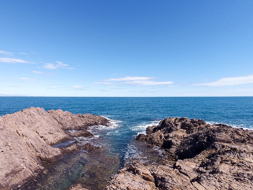 Rugged Rocky Coastline with Blue Ocean and Clear Sky