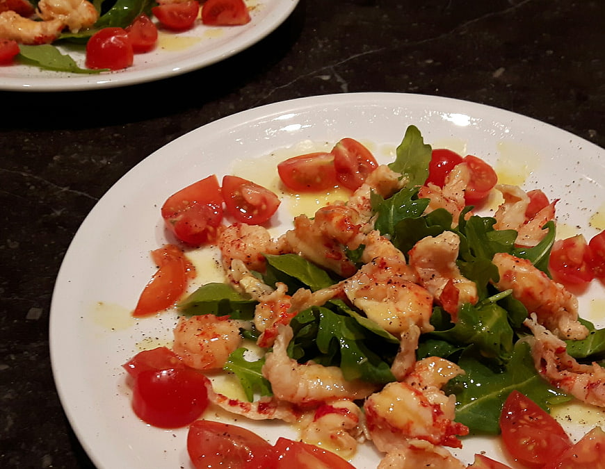 Crayfish Salad with Tomatoes and Arugula on White Plate