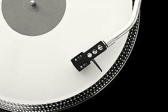 Close-up of white vinyl record on turntable with tonearm