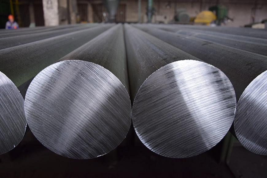 Close-up of polished steel rods in industrial factory setting