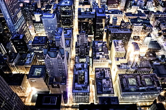 Aerial Night View of Dense City Skyline with Illuminated Skyscrapers