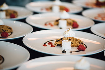 Gourmet dessert plates with biscotti, meringue, and raspberry