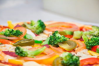 Close-up of colorful vegetable pizza with broccoli and peppers