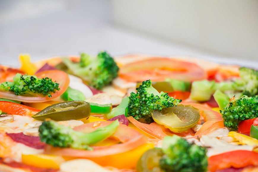 Close-up of colorful vegetable pizza with broccoli and peppers