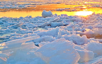 Golden Sunset Over Frozen Lake with Ice Chunks