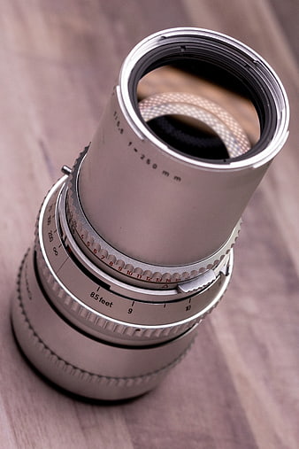 Vintage Silver Camera Lens on Wooden Surface