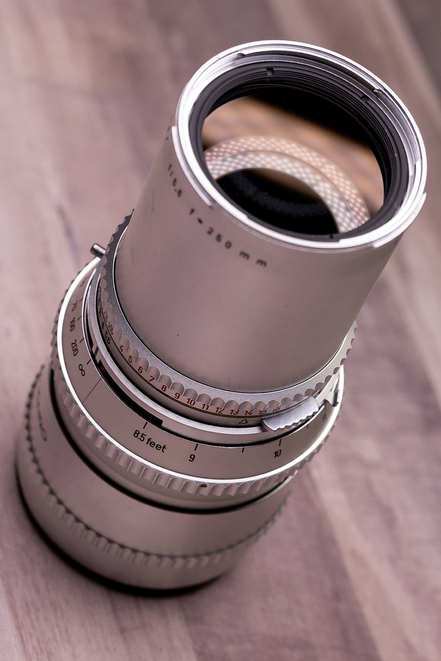 Vintage Silver Camera Lens on Wooden Surface