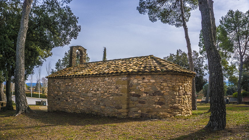 Old Stone Chapel with Bell Tower in Pine Forest