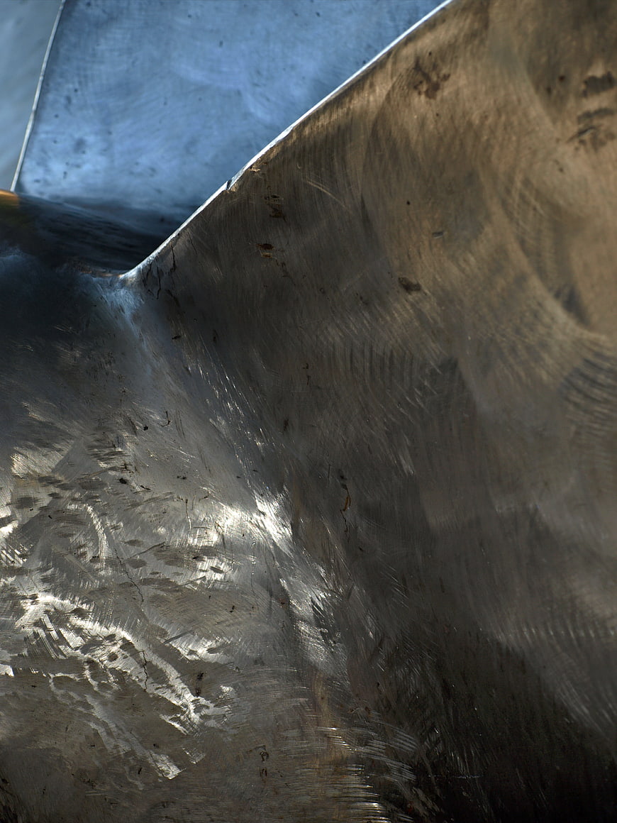 Abstract brushed metal texture with industrial scratches and reflections