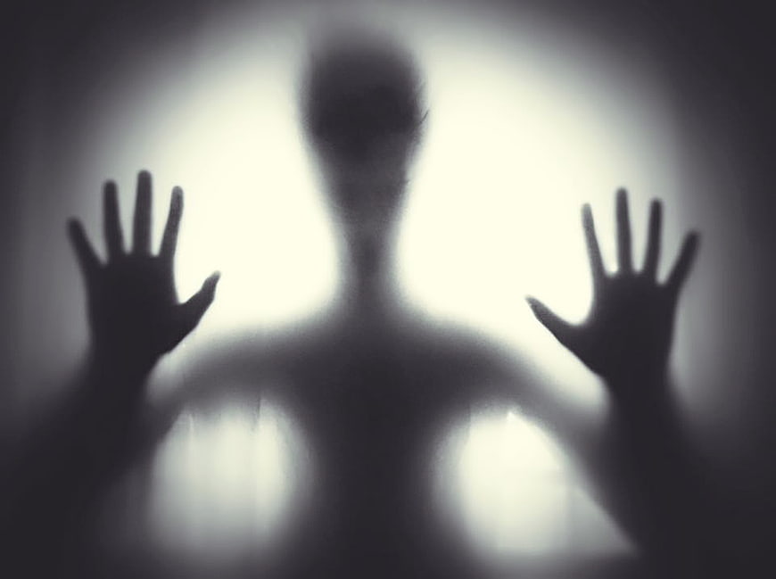 Silhouette of a person behind frosted glass