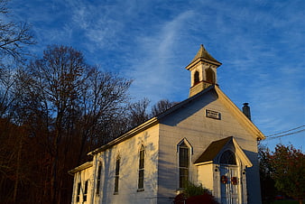 White Methodist Church at Sunrise with Blue Sky