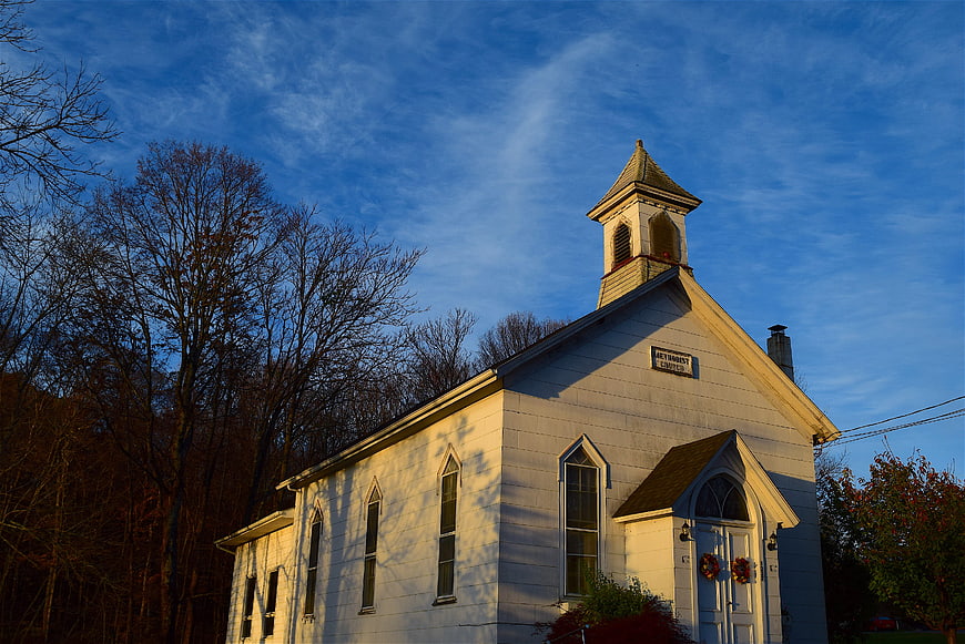 White Methodist Church at Sunrise with Blue Sky