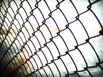 Close-up of rusty chain-link fence with shallow depth of field