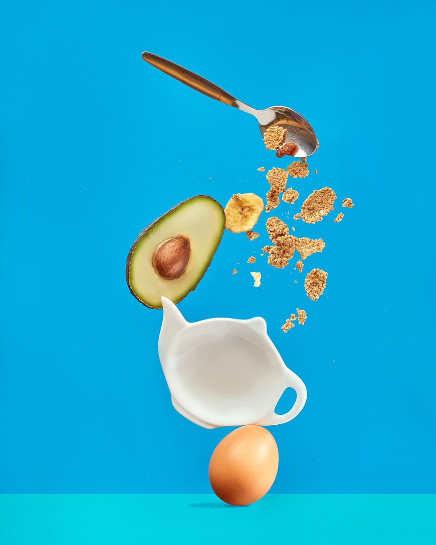 Levitating Healthy Breakfast Ingredients on Blue Background
