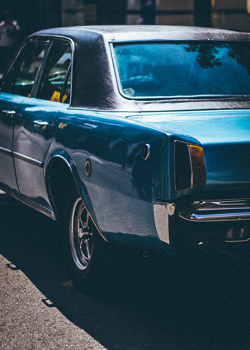 Rear view of vintage blue classic car parked on street