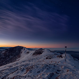Snowy Mountain Ridge at Twilight with Starry Sky