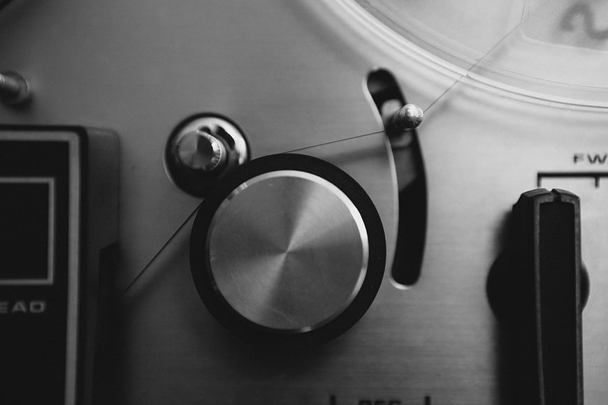Close-up of vintage sewing machine tension dial and thread