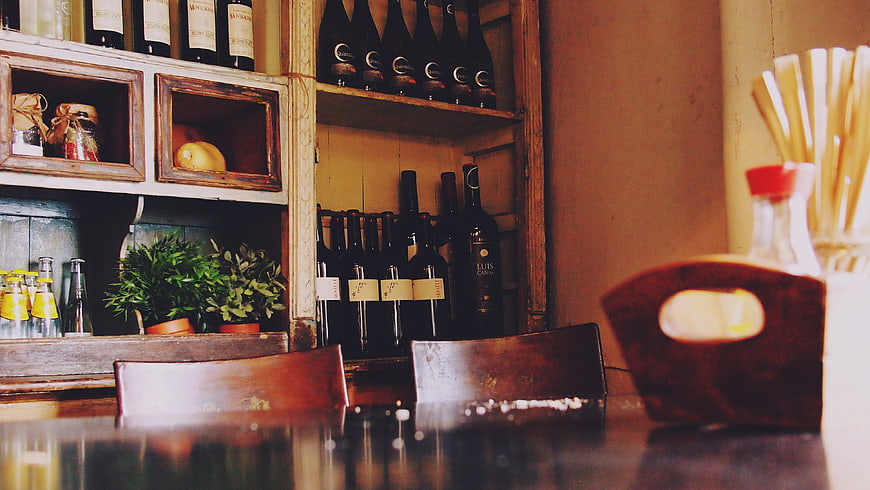 Rustic Bar Interior with Wine Bottles and Wooden Shelves