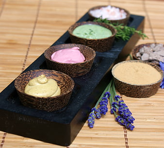 Colorful Spa Body Scrubs And Creams In Woven Bowls