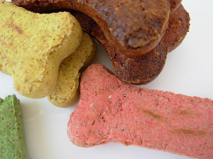 Colorful Bone-Shaped Dog Treats On White Background