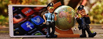 Cybersecurity Concept With Police Figurines, Globe, And Tablet