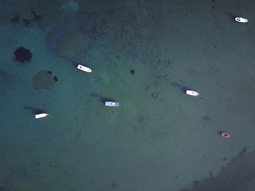 Aerial view of boats anchored in turquoise tropical waters