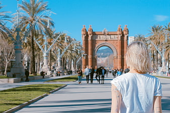 Woman with tattoo looking at Arc de Triomf in Barcelona