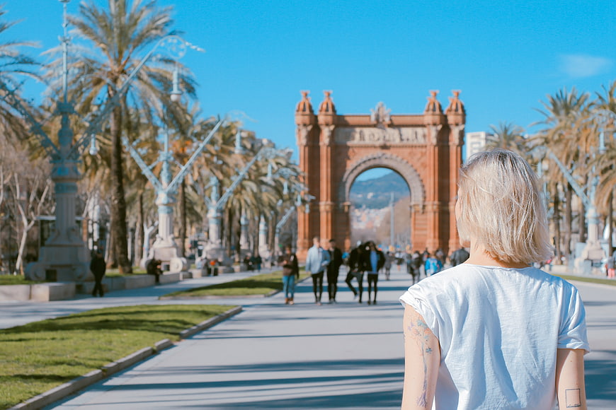 Woman with tattoo looking at Arc de Triomf in Barcelona