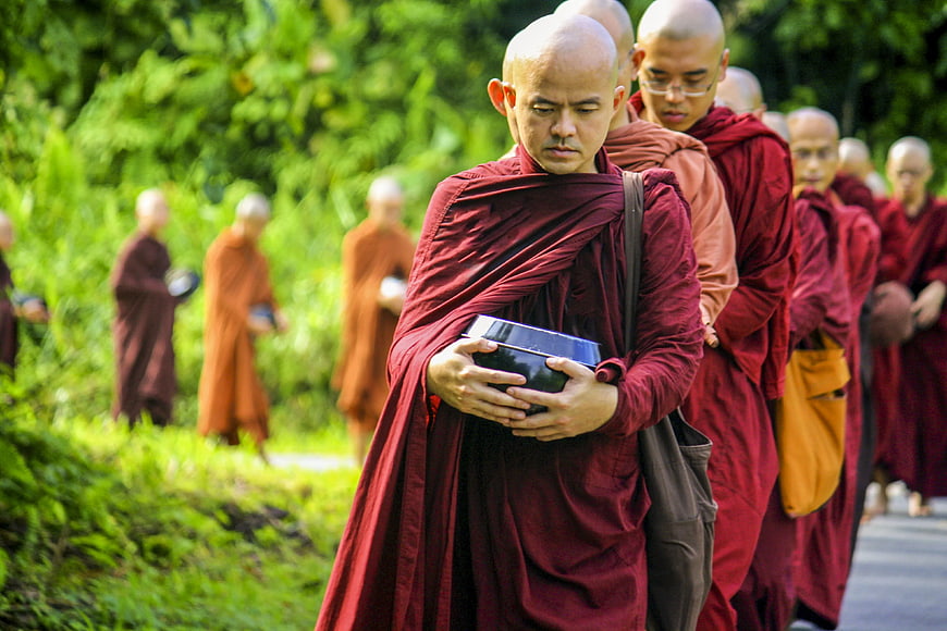 Buddhist Monks Walking in Line with Alms Bowls