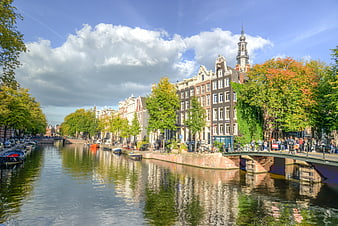 Amsterdam Canal with Traditional Dutch Architecture and Bridge