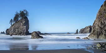 Long exposure coastal landscape with sea stacks and misty waves