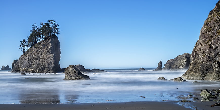 Long exposure coastal landscape with sea stacks and misty waves