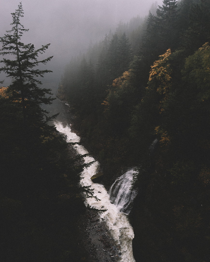 Misty Mountain River with Waterfall in Dark Forest