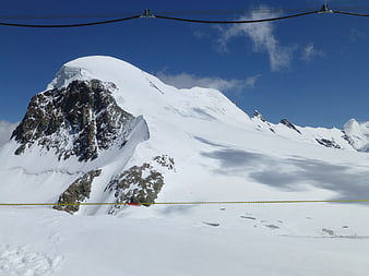 Snowy Breithorn Mountain Peak with Cable Car Lines