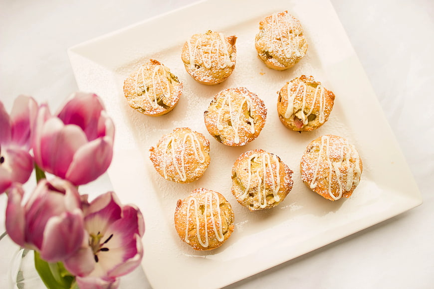 Mini Muffins with Icing and Tulips on White Plate