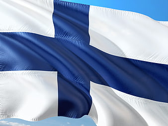 Waving Finnish Flag Against Blue Sky