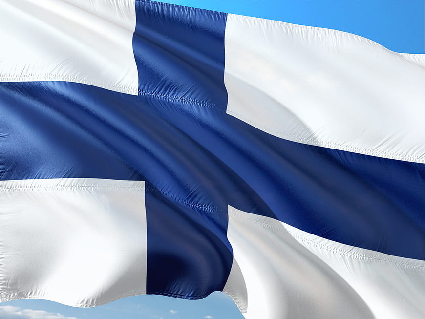 Waving Finnish Flag Against Blue Sky