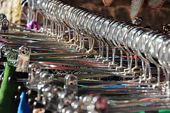 Close-up of metal clothing hangers on a rack