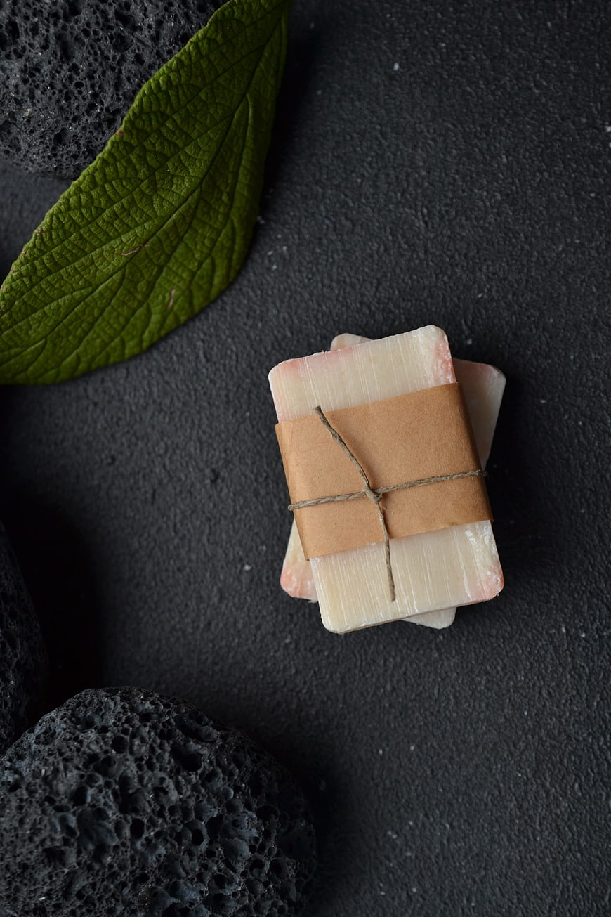 Handmade Natural Soap Gift Wrapped in Kraft Paper on Dark Background