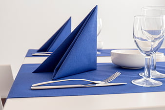 Elegant Blue Napkin Table Setting With Silverware And Glassware